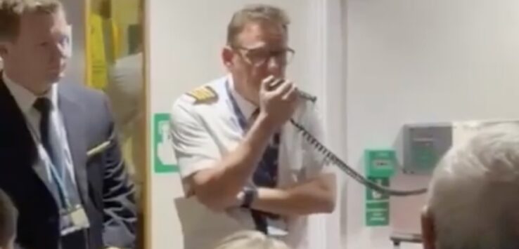 a man holding a microphone in front of a group of people