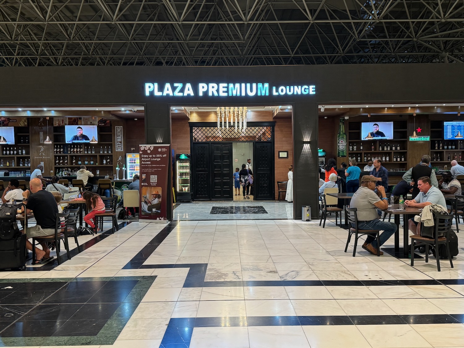 a group of people sitting at tables in a restaurant