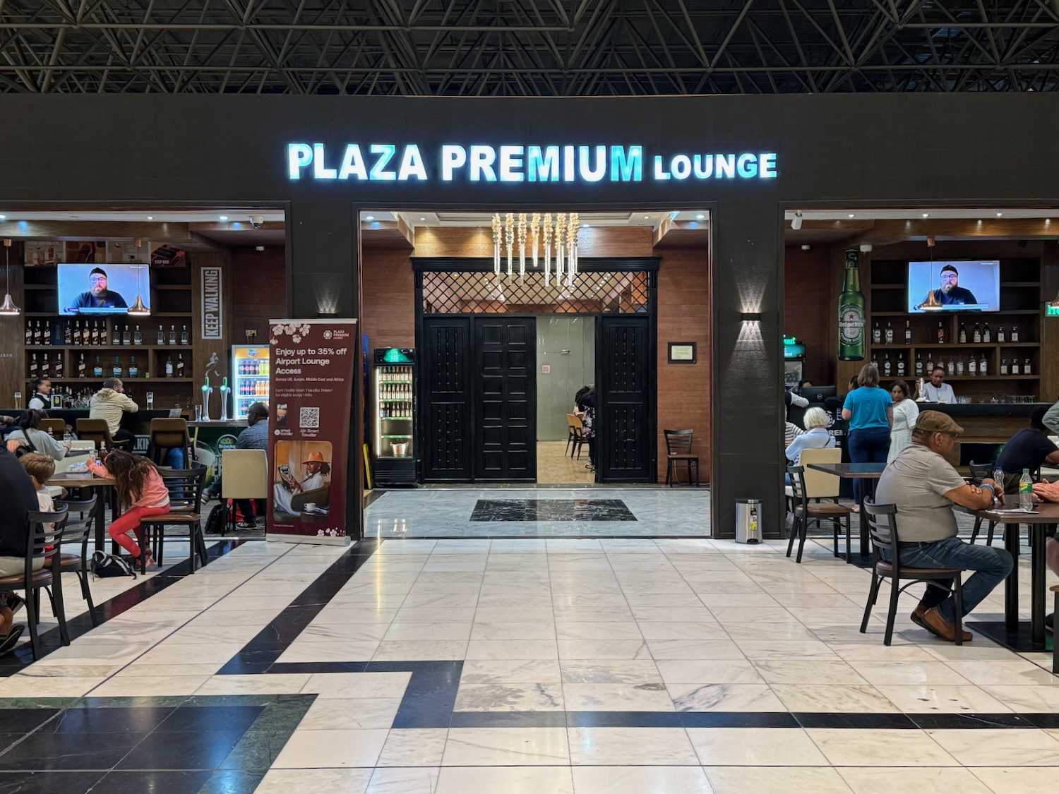 a group of people sitting at tables in a restaurant