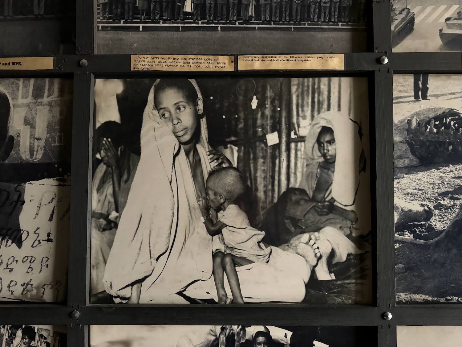 a black and white photo of a woman holding a baby