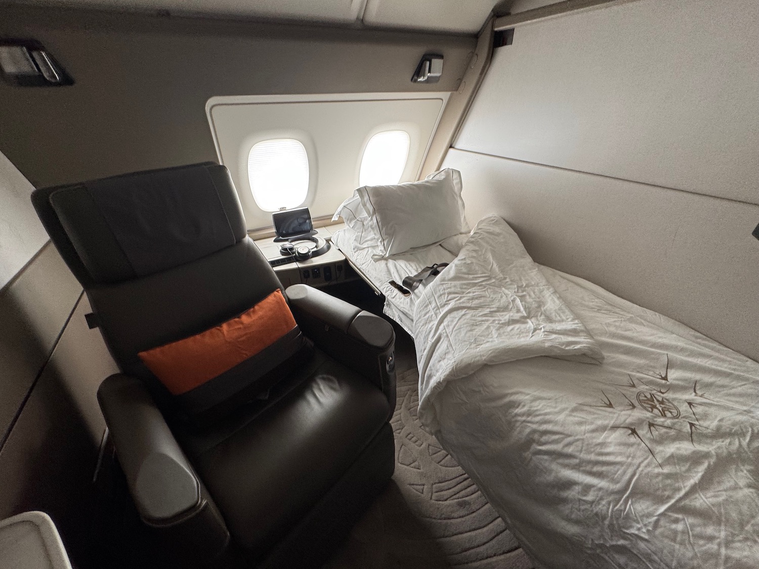 a bed and chair in an airplane