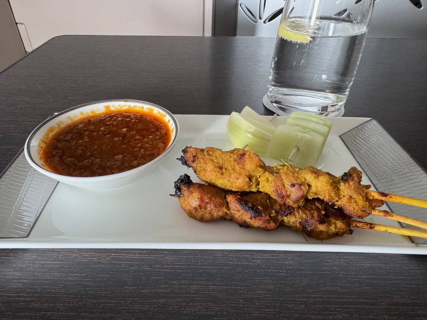 a plate of food with a glass of water and a glass of water