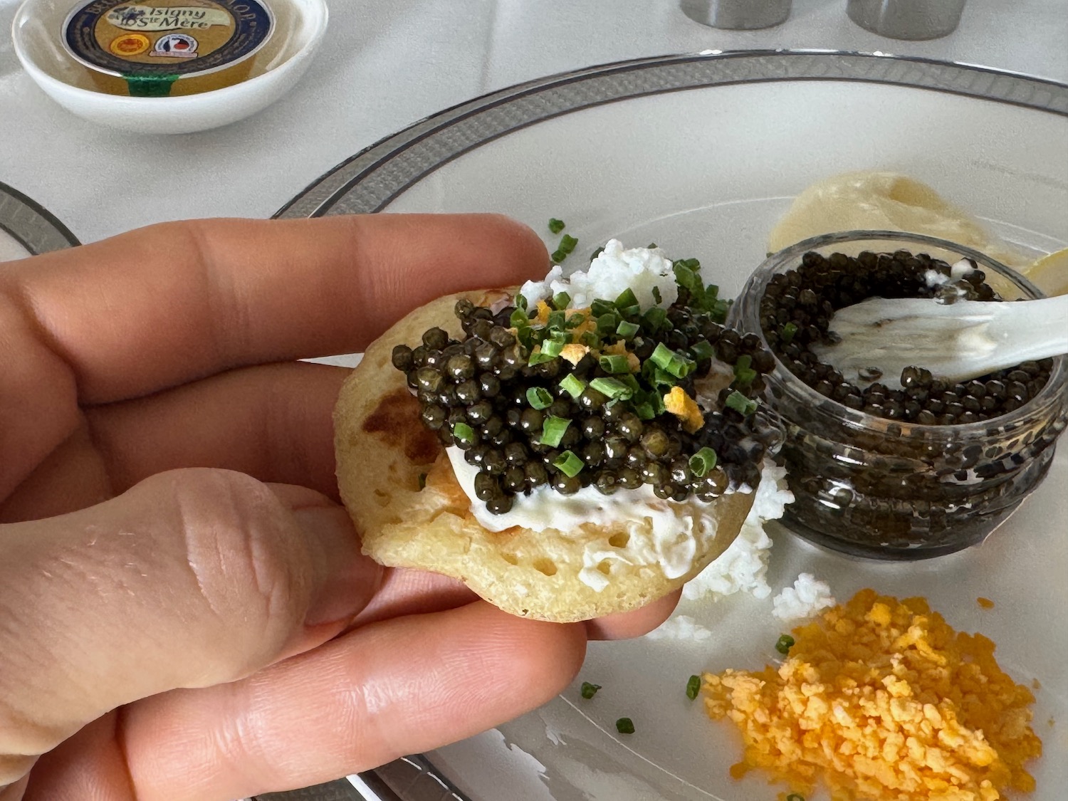 a person holding a small piece of food