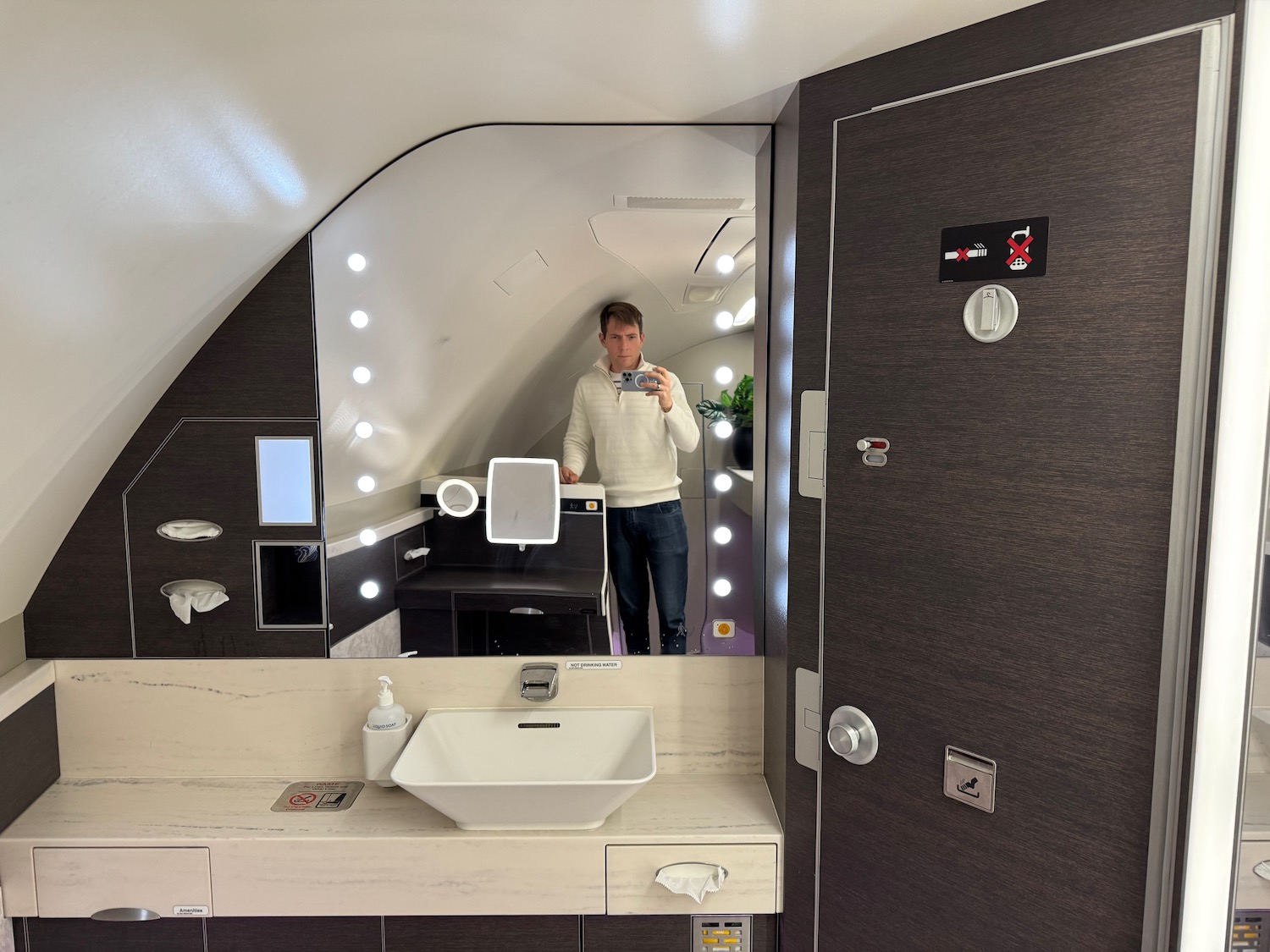 a man taking a selfie in a bathroom