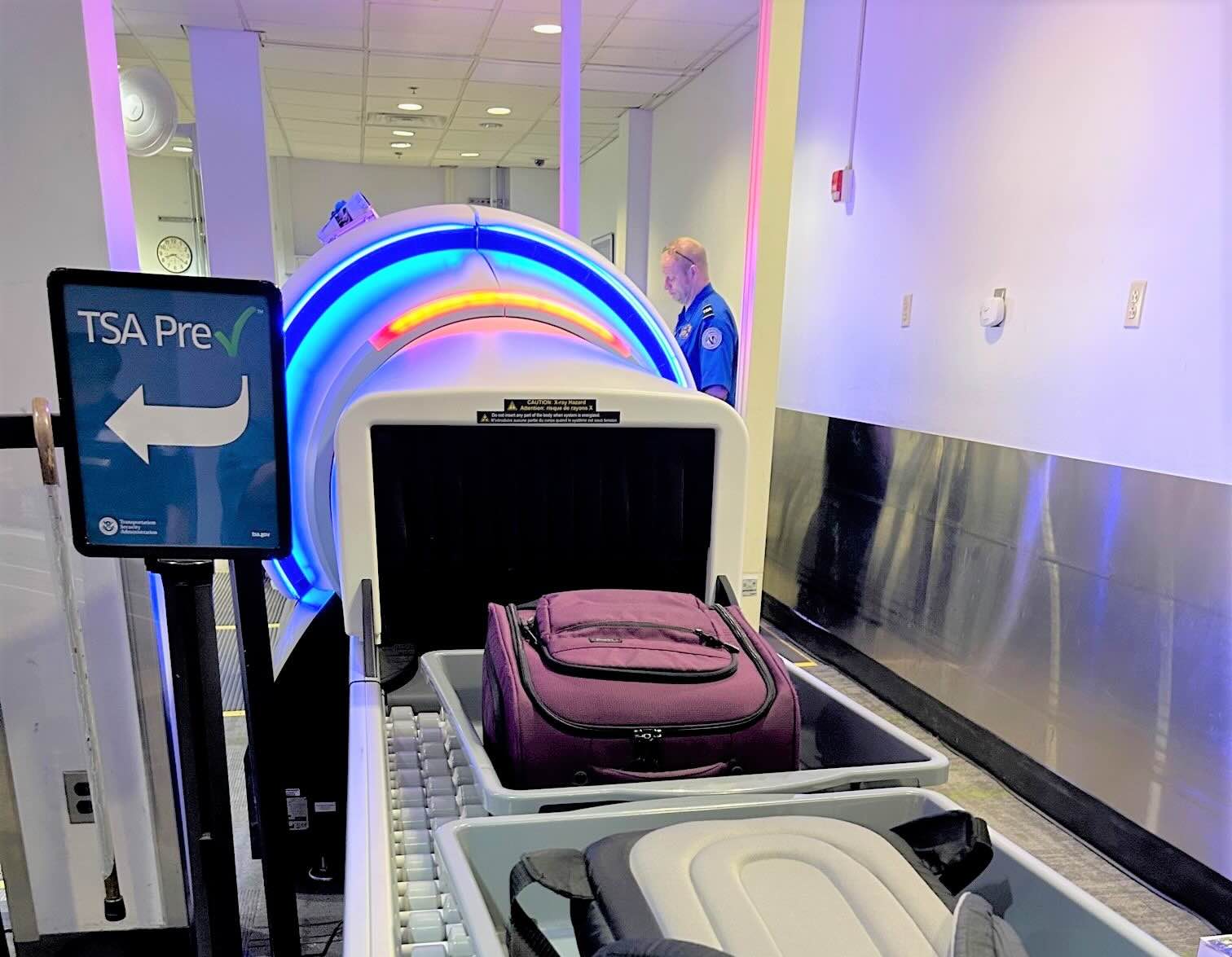luggage in a machine at an airport
