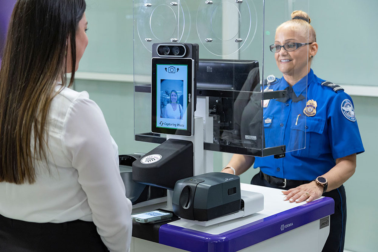 a woman standing next to a woman at a cash register