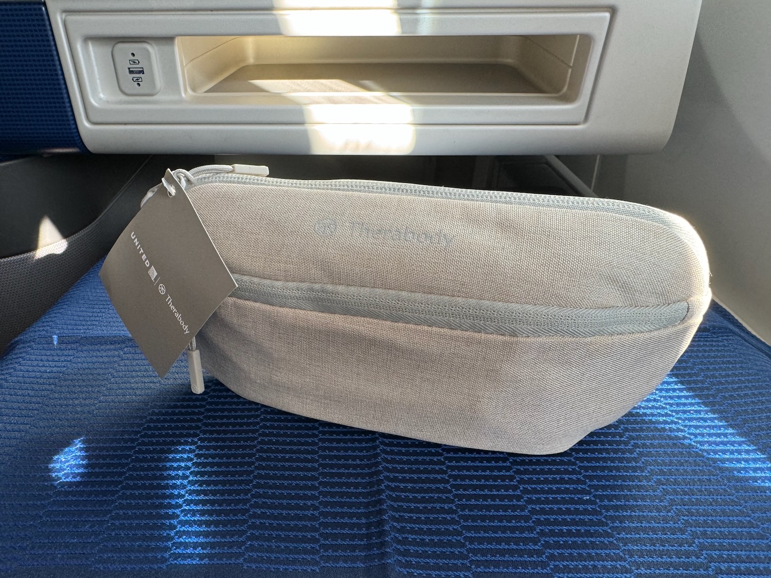 a small white bag on a blue surface