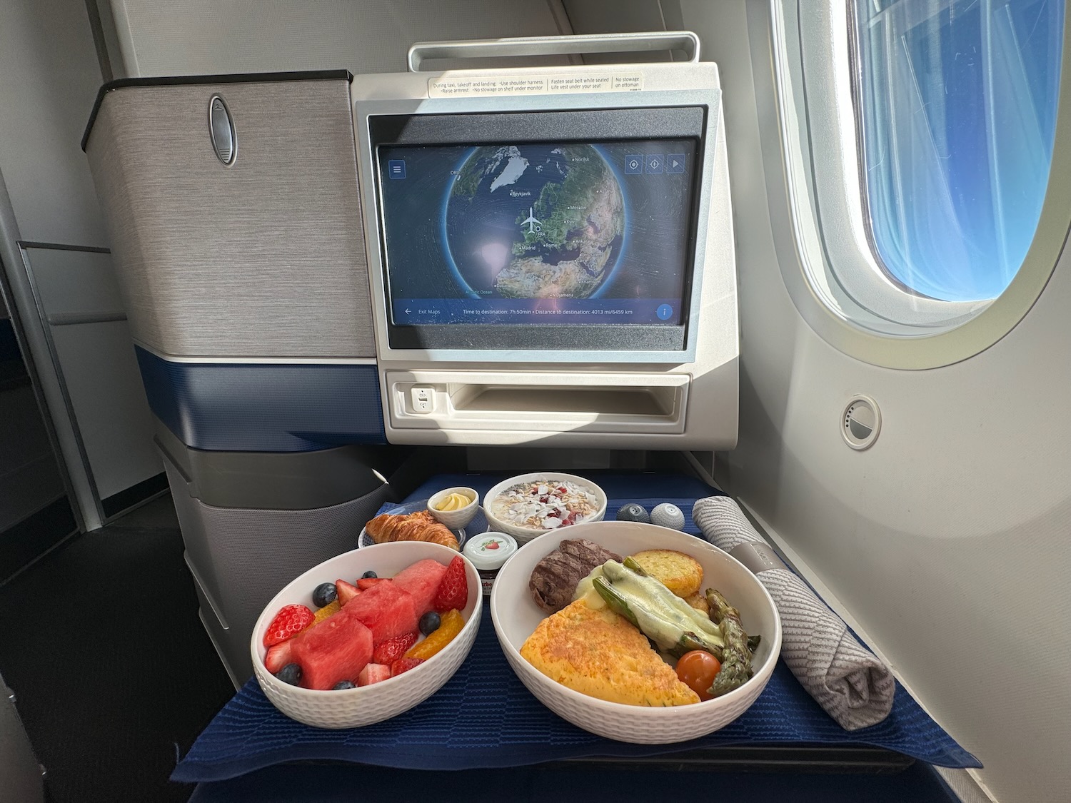 food in bowls on a table in an airplane