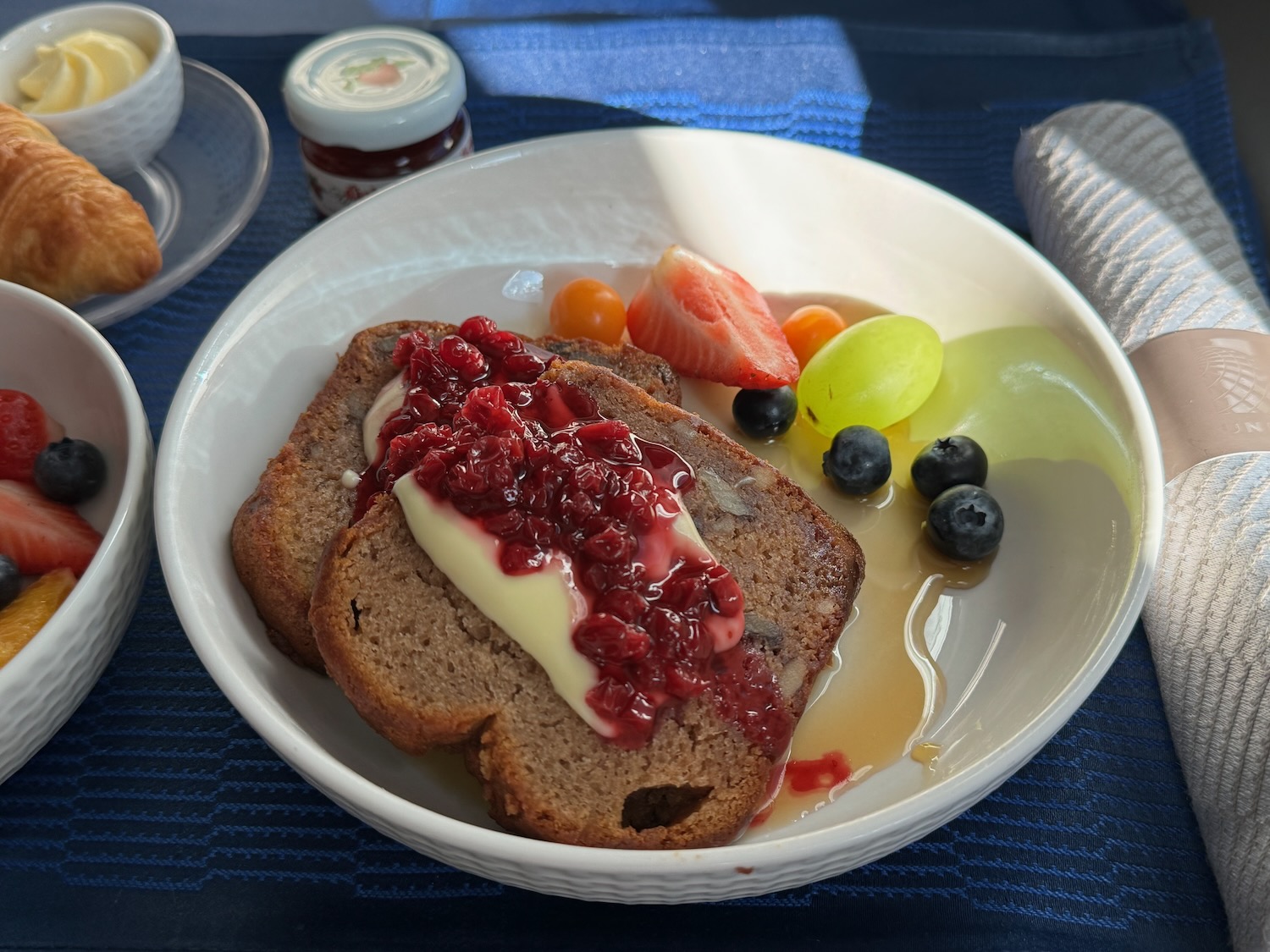 a plate of food with fruit and jam