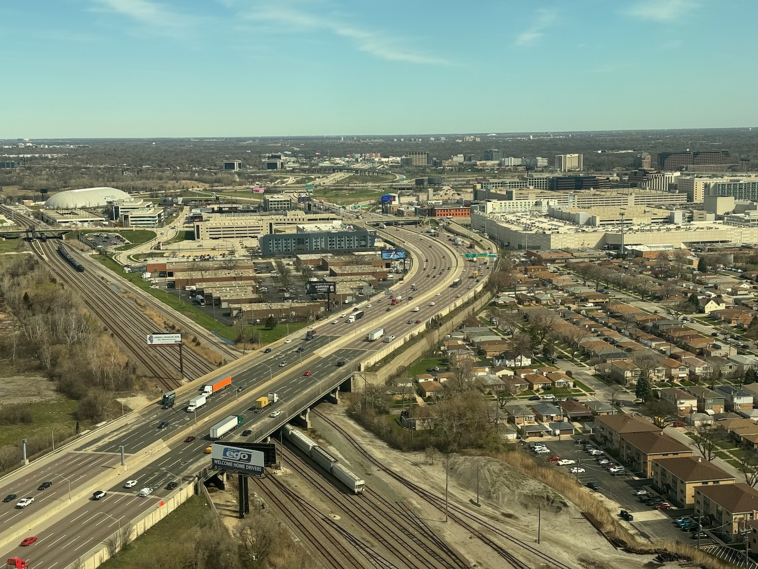 a highway with cars and a bridge over a city