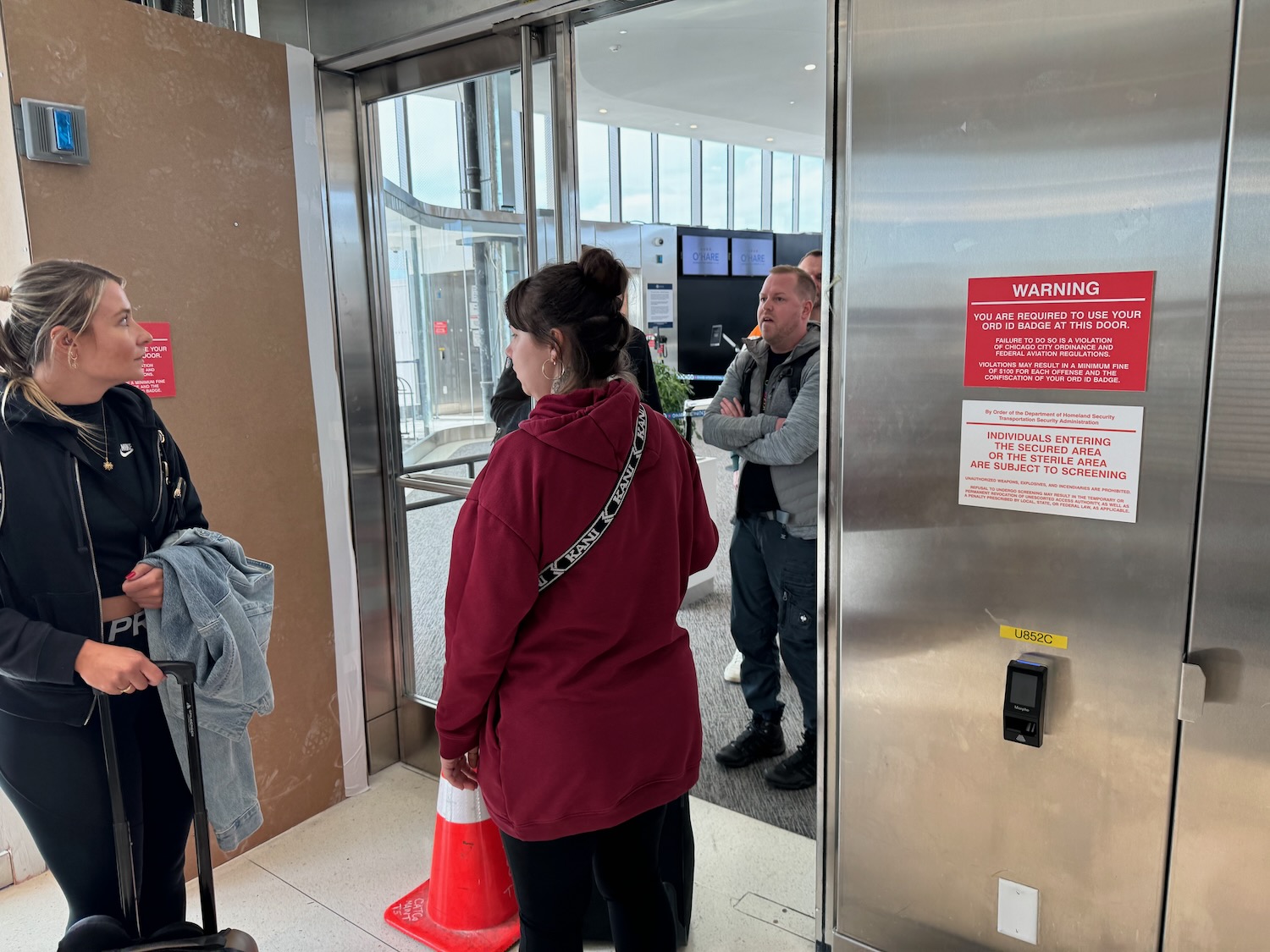 a woman standing in front of an elevator