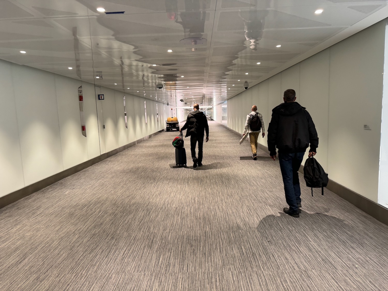a group of people walking in a hallway