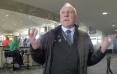 a man in a black coat and tie