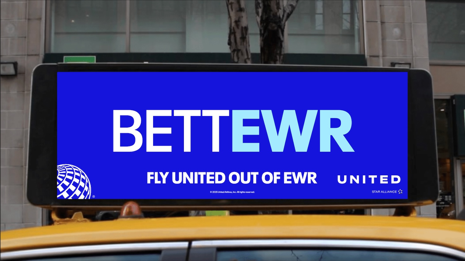 a sign on top of a yellow taxi