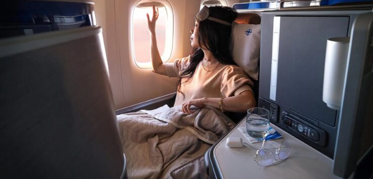 a woman in a bed looking out a window