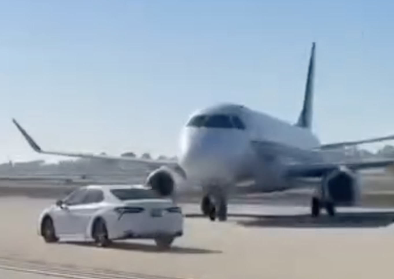a white airplane and a car