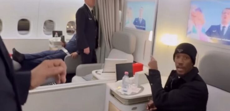 a man sitting in a chair in a plane