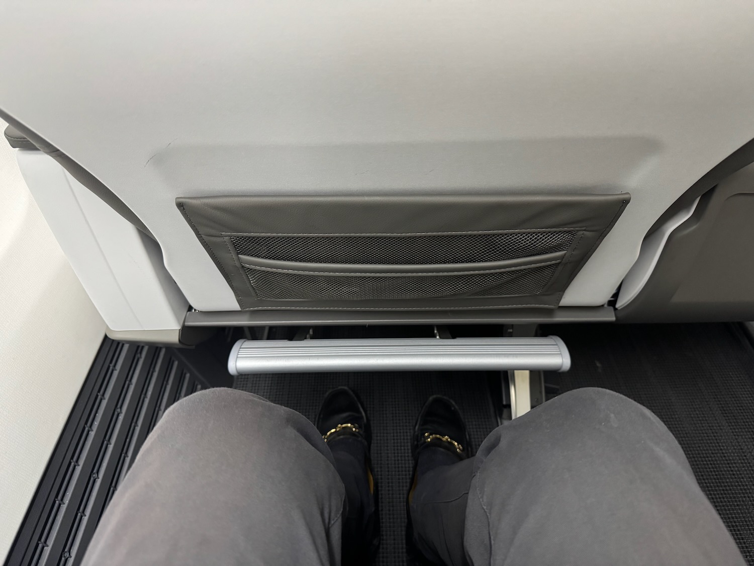 a person's legs in a seat