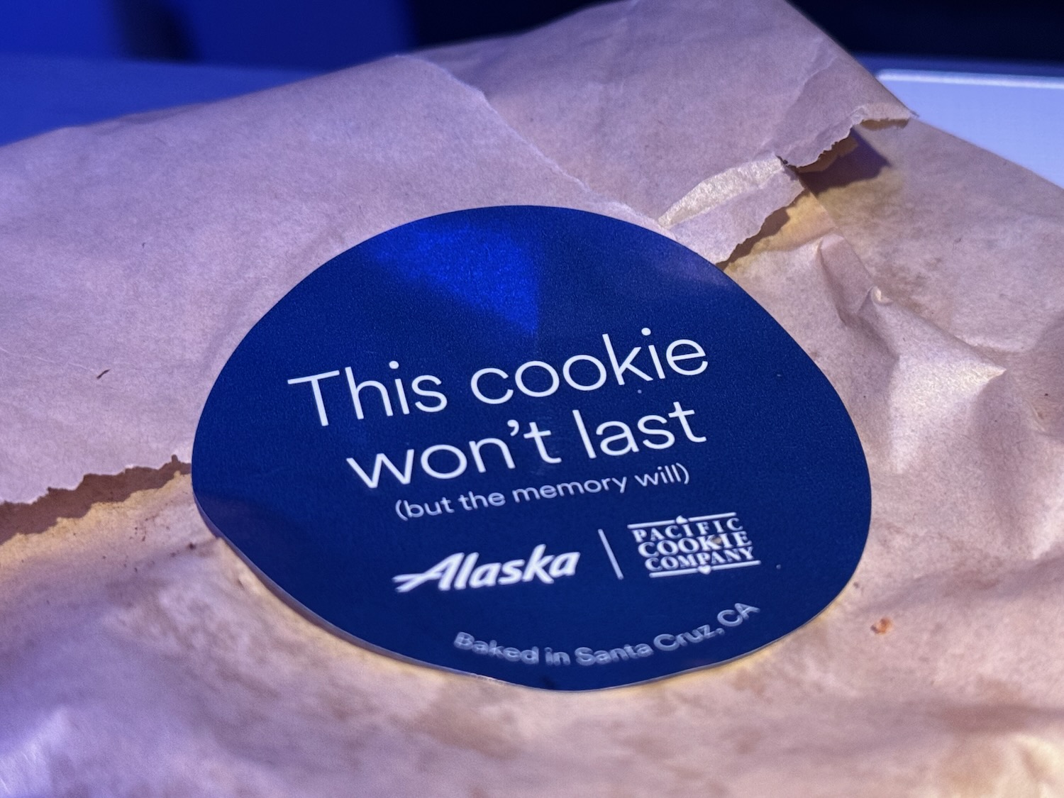 a blue sticker on a brown paper bag