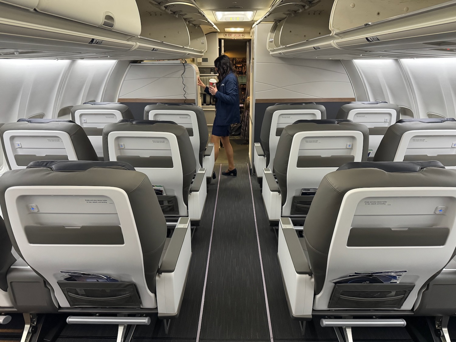 a woman standing in an airplane