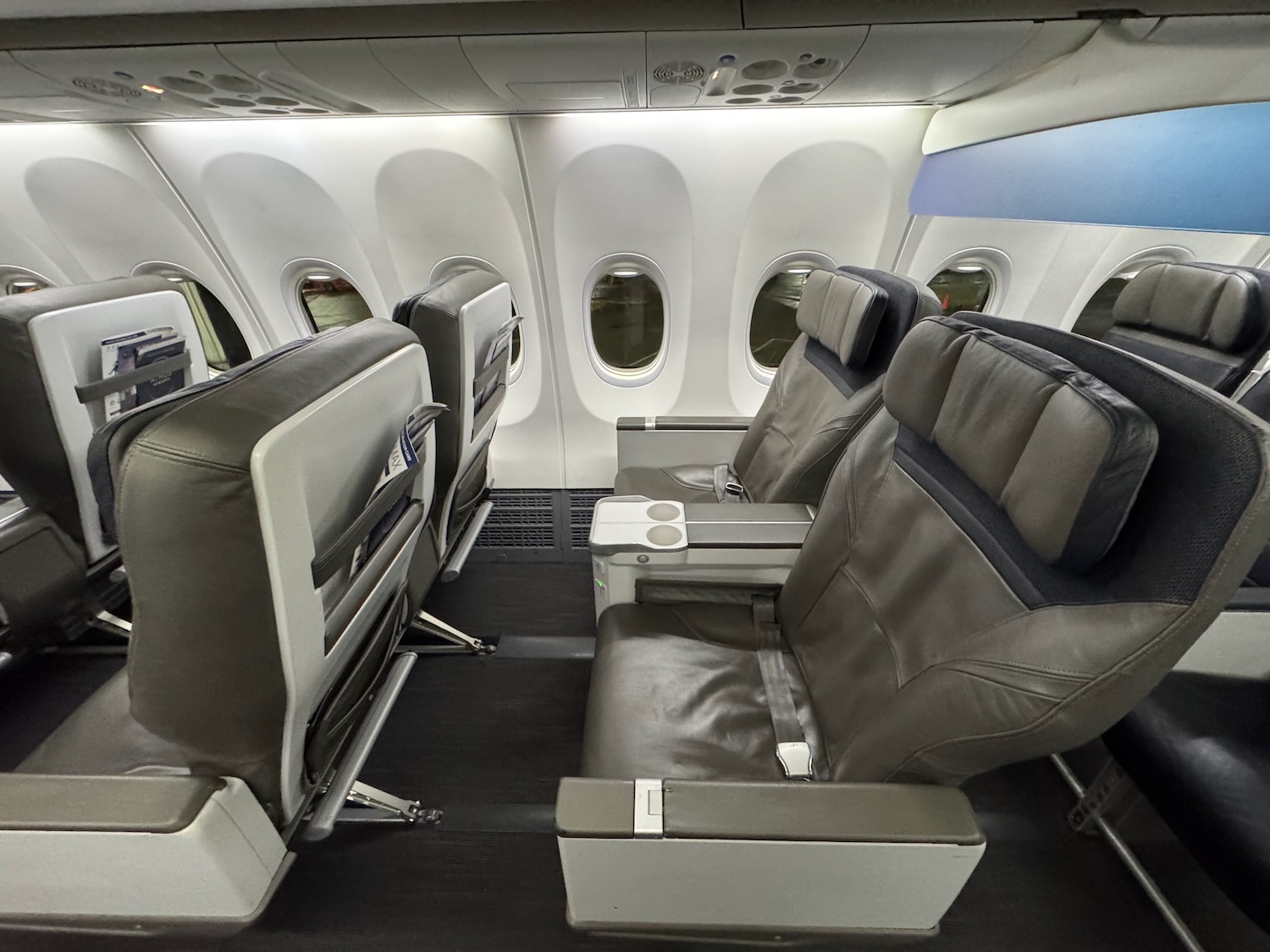 the inside of an airplane with seats and windows