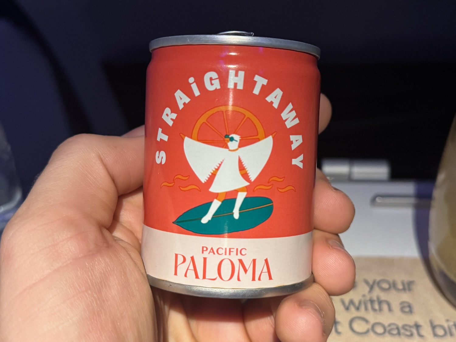 a hand holding a can of soda