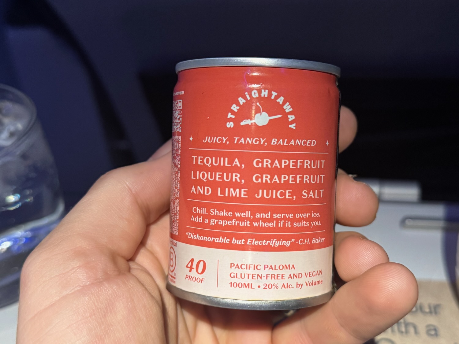 a hand holding a can of liquid