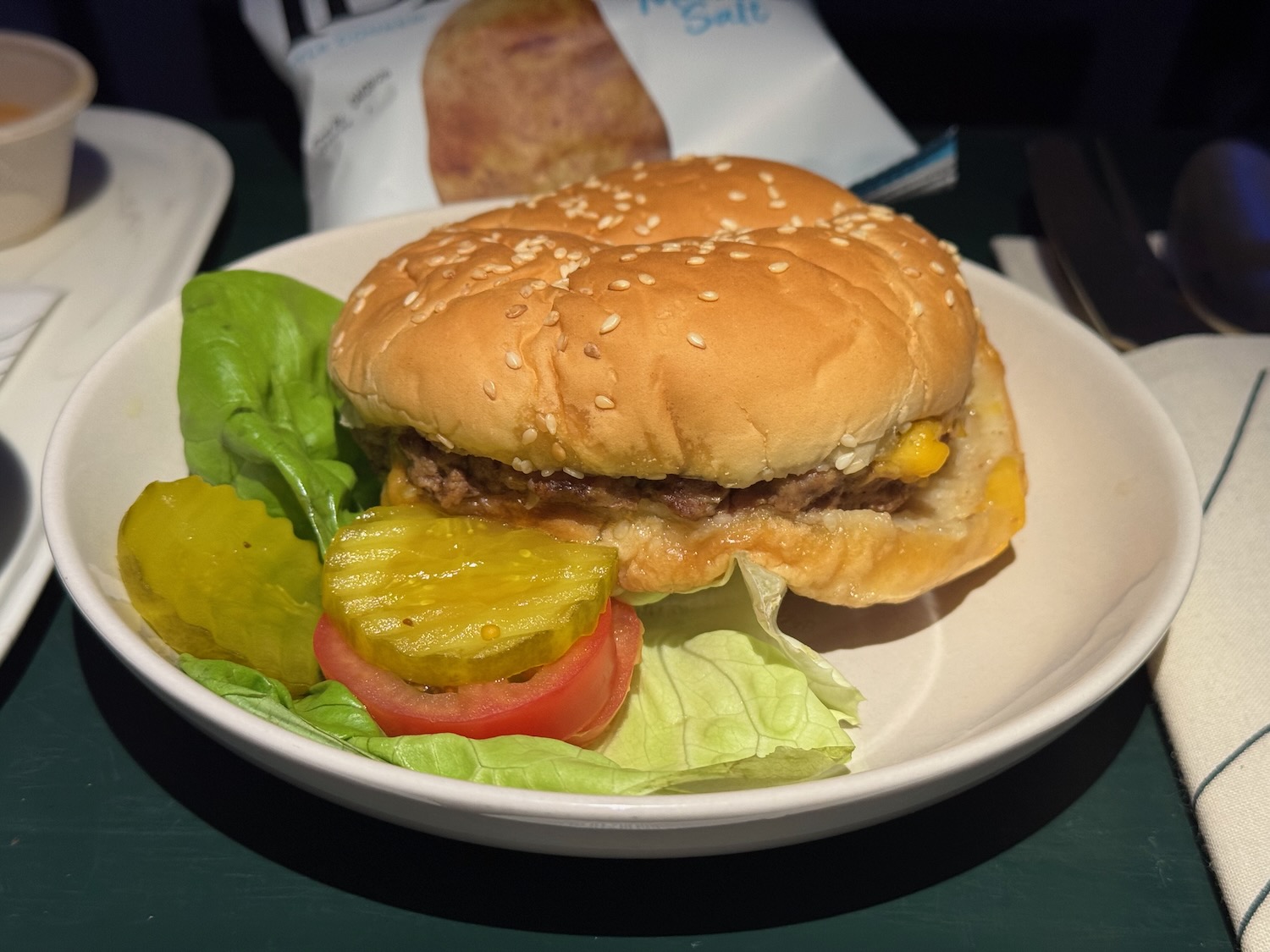 a burger and pickles on a plate
