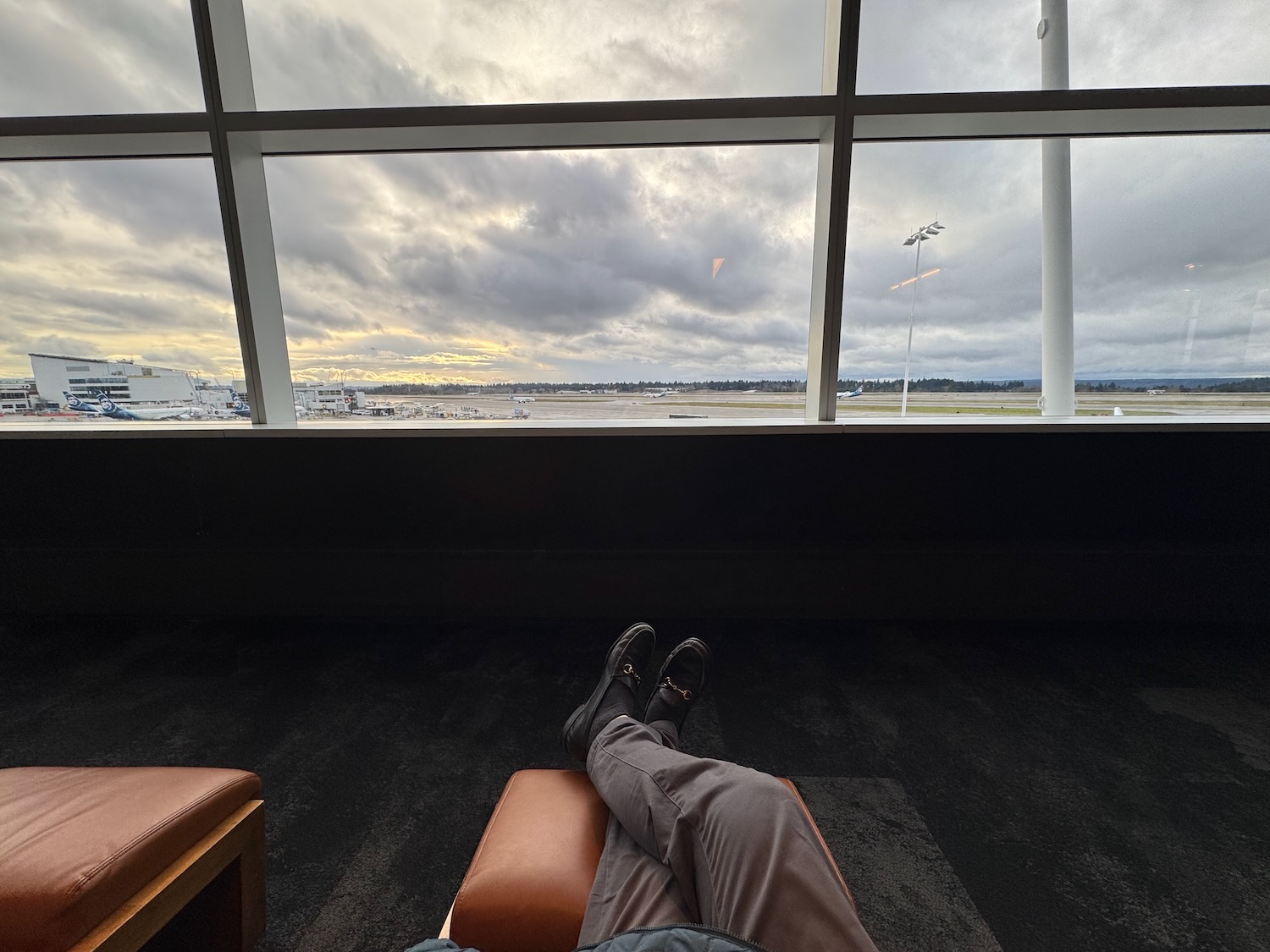 a person lying on a chair with their feet up