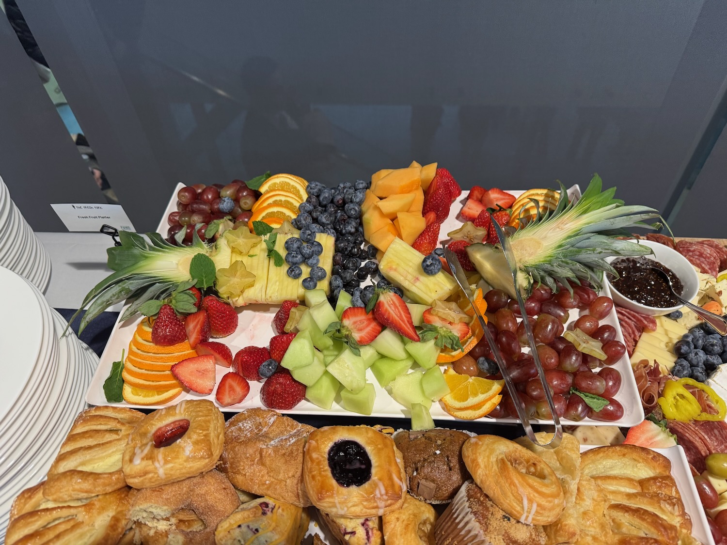 a plate of fruit and pastries