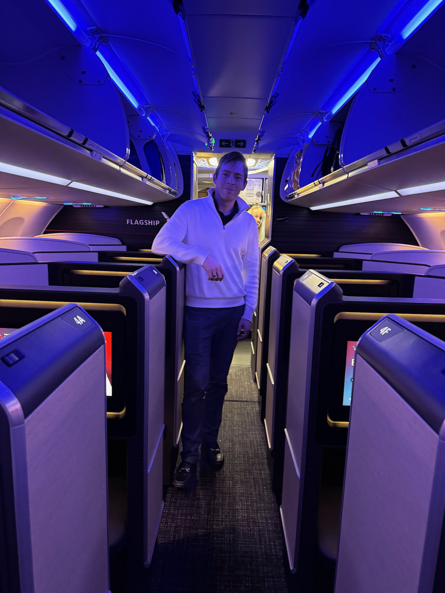 a man standing in a row of seats