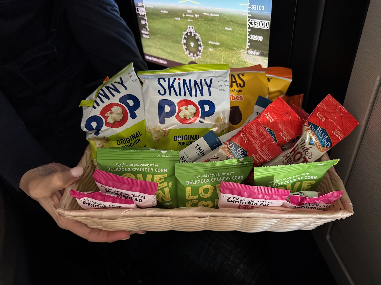 a basket of snacks in a person's hand