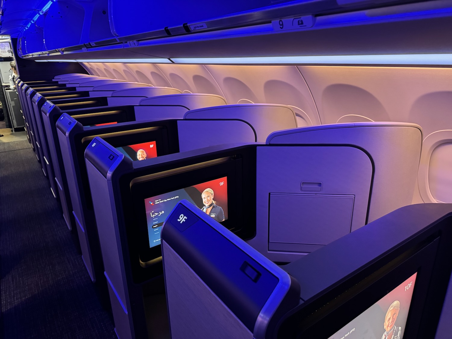 a row of seats with monitors on the side