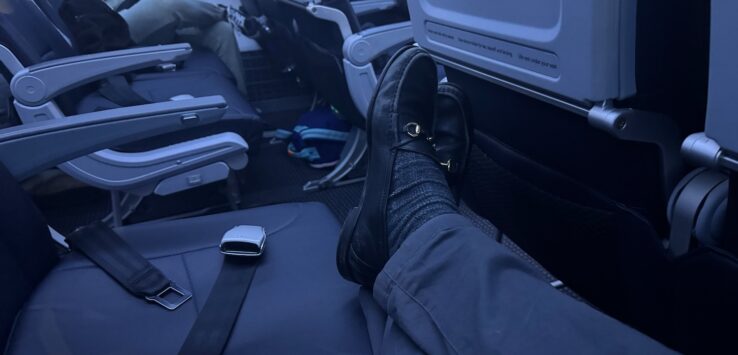 a person's feet on an airplane