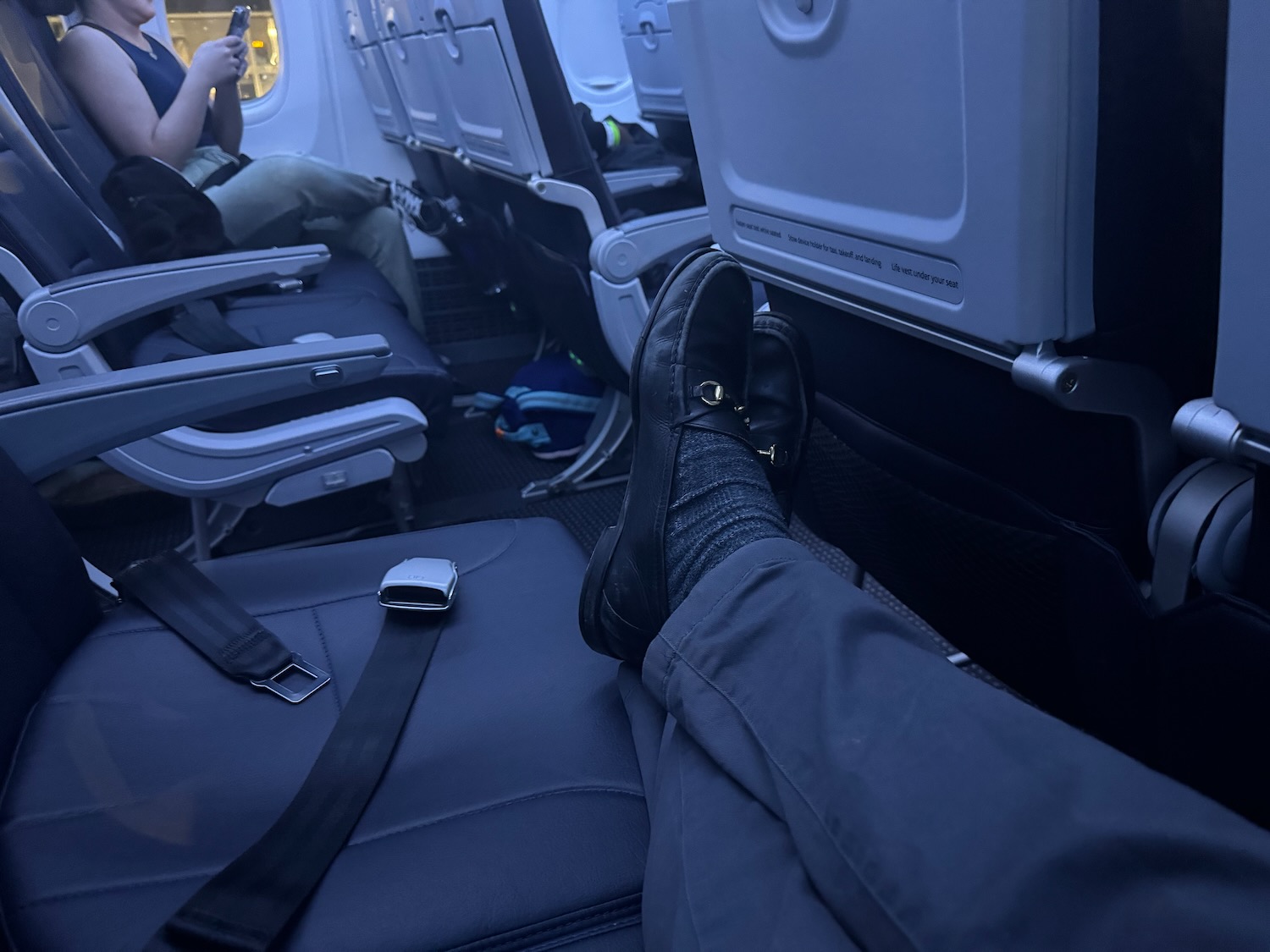 a person's feet on an airplane