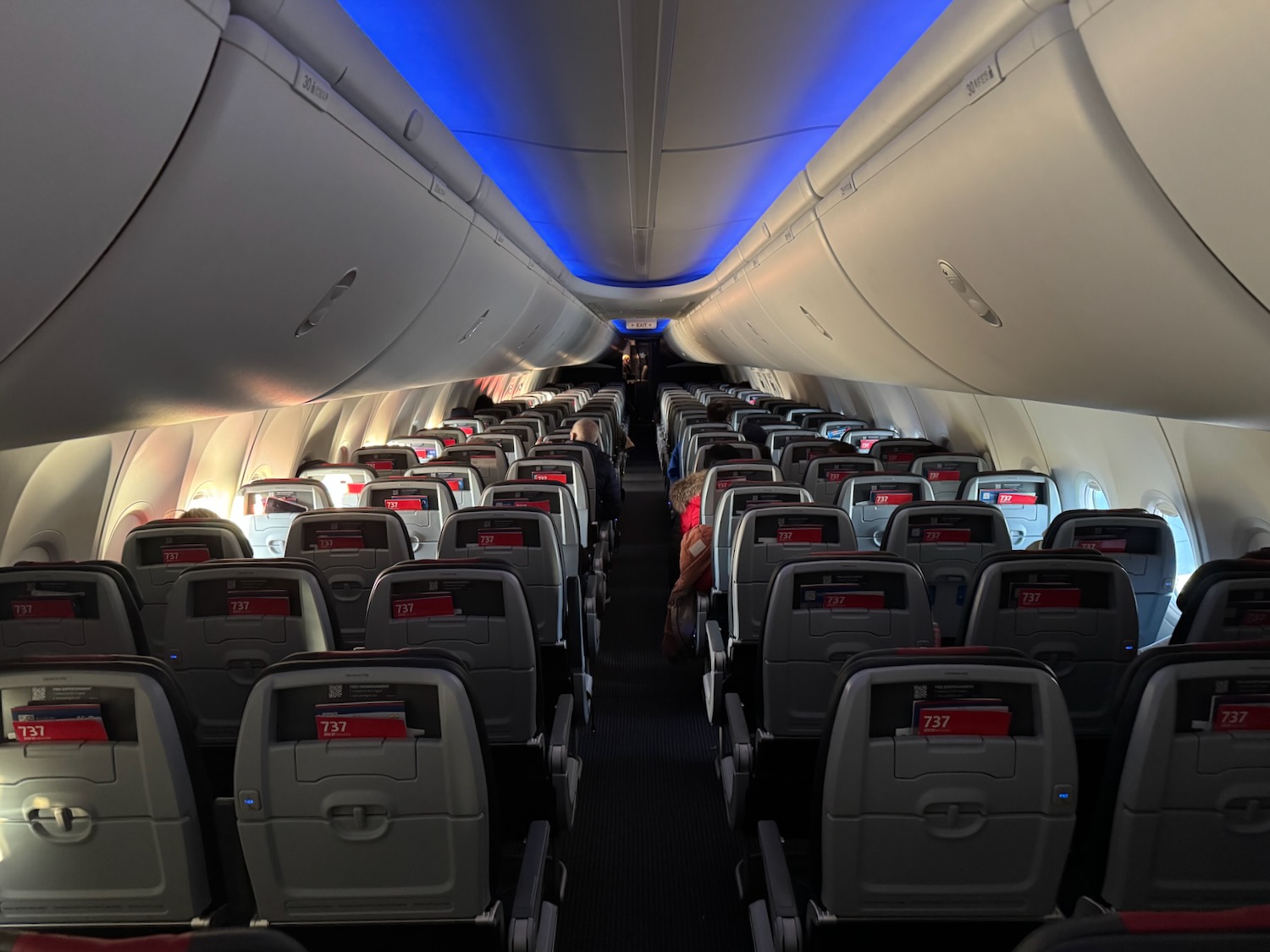 an airplane with seats and a person sitting in the back