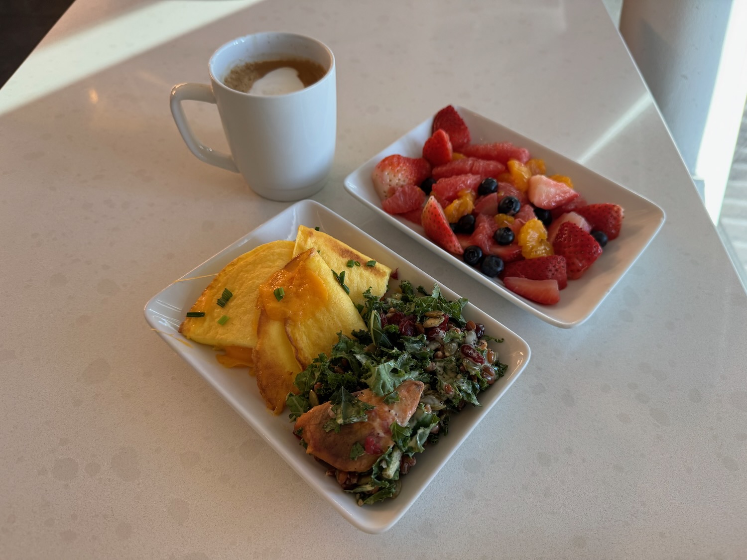 a plate of fruit and a cup of coffee