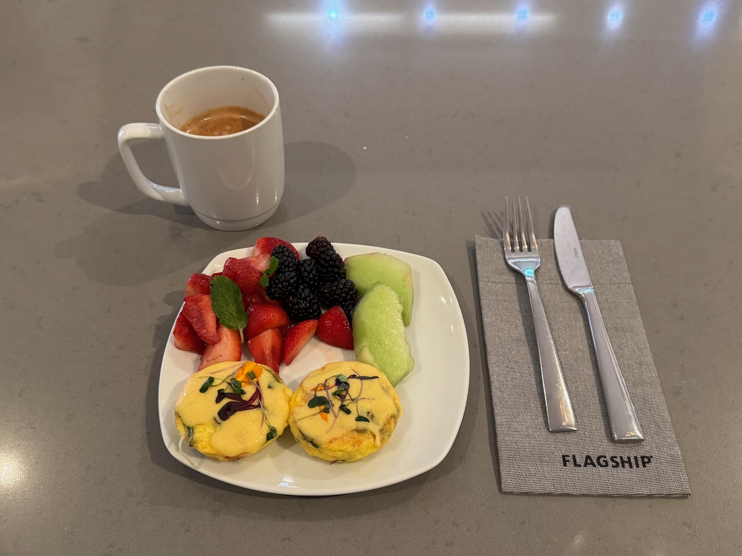 a plate of fruit and a cup of coffee