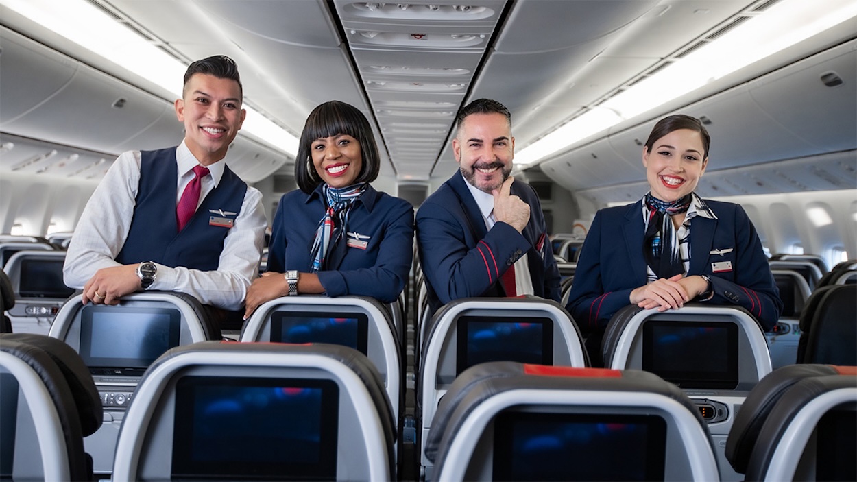a group of people in uniform sitting on an airplane