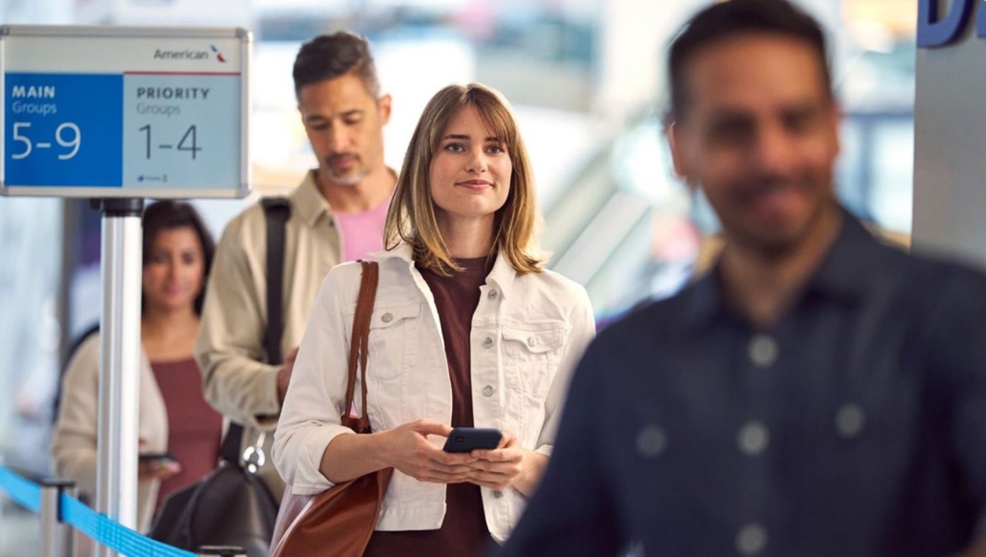 a woman holding a phone and looking at another woman