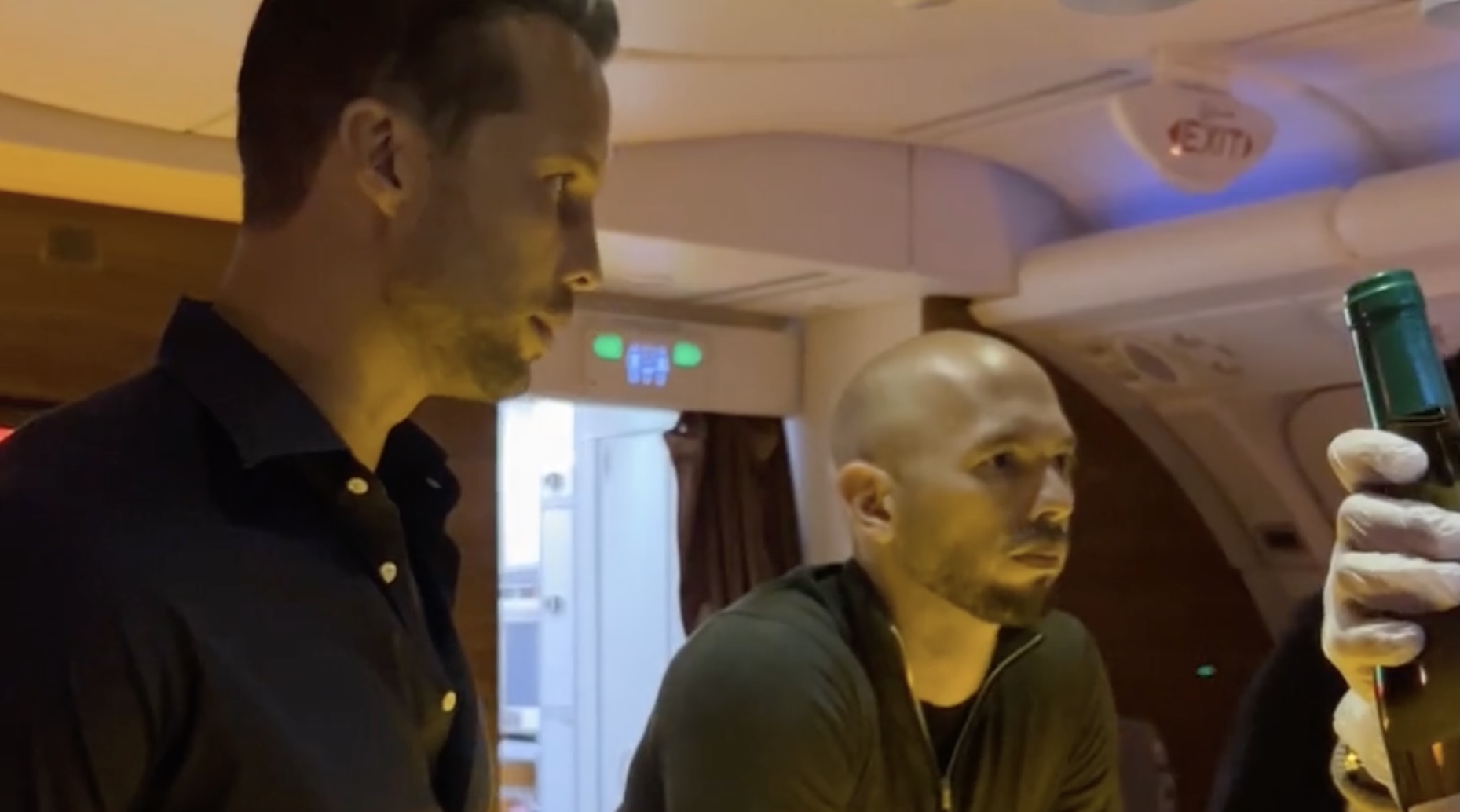 two men sitting in a plane