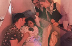 a group of people around a baby