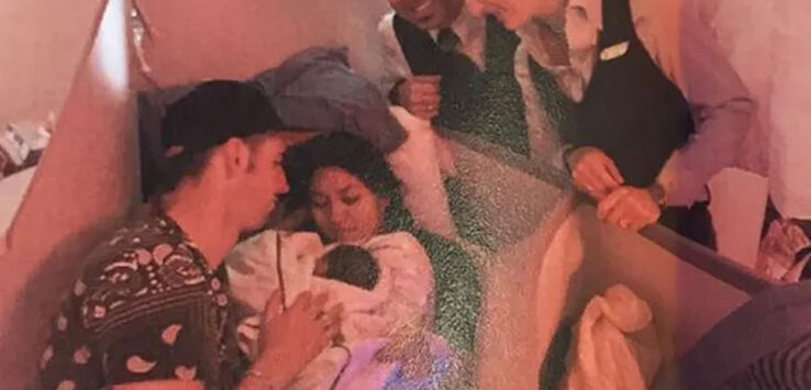 a group of people around a baby