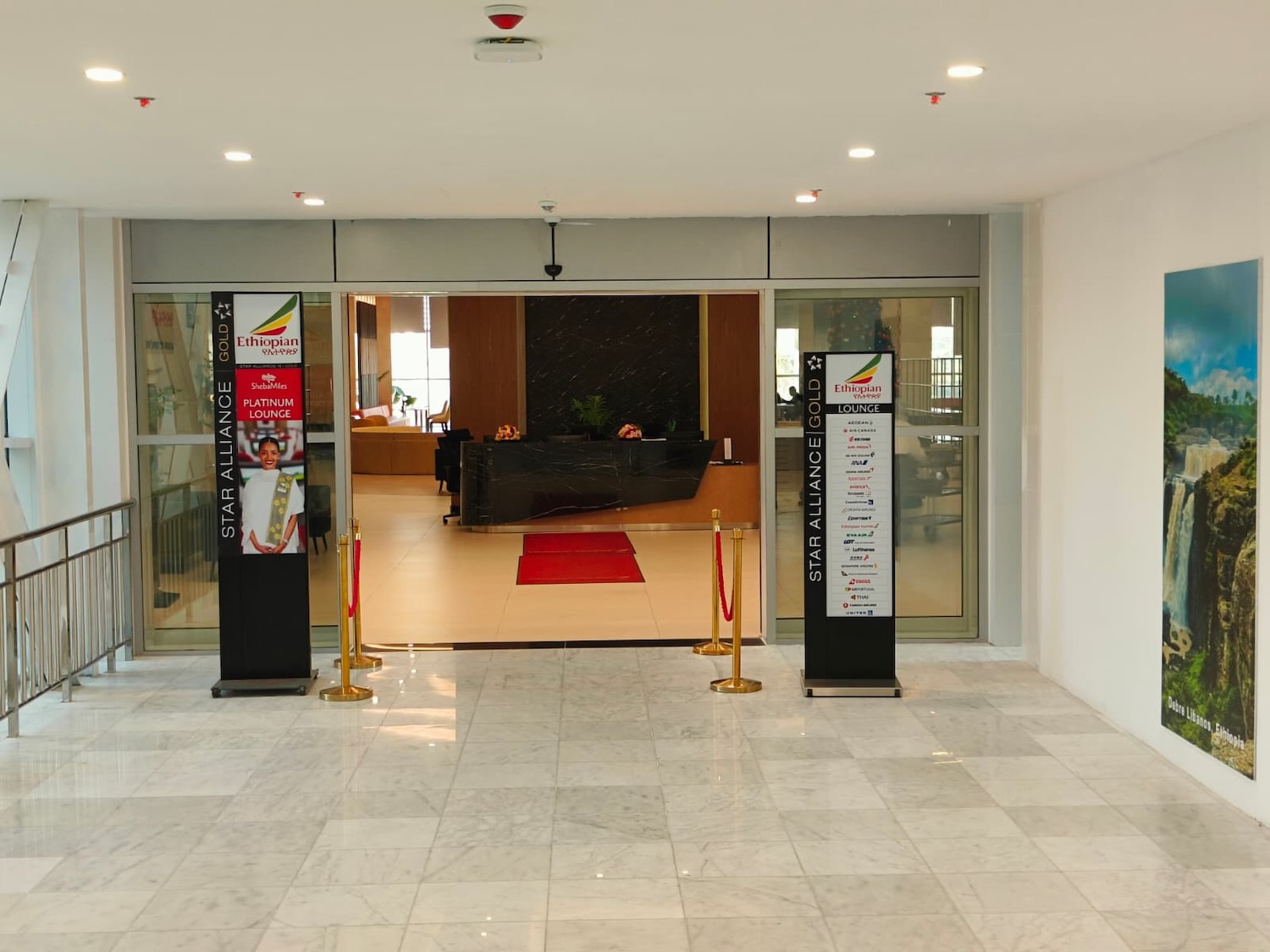 a lobby with a reception desk and signs