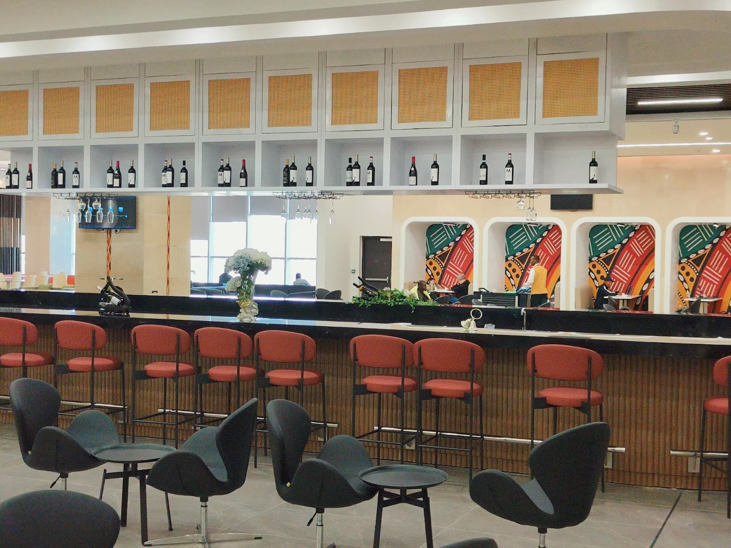 a bar with chairs and a counter