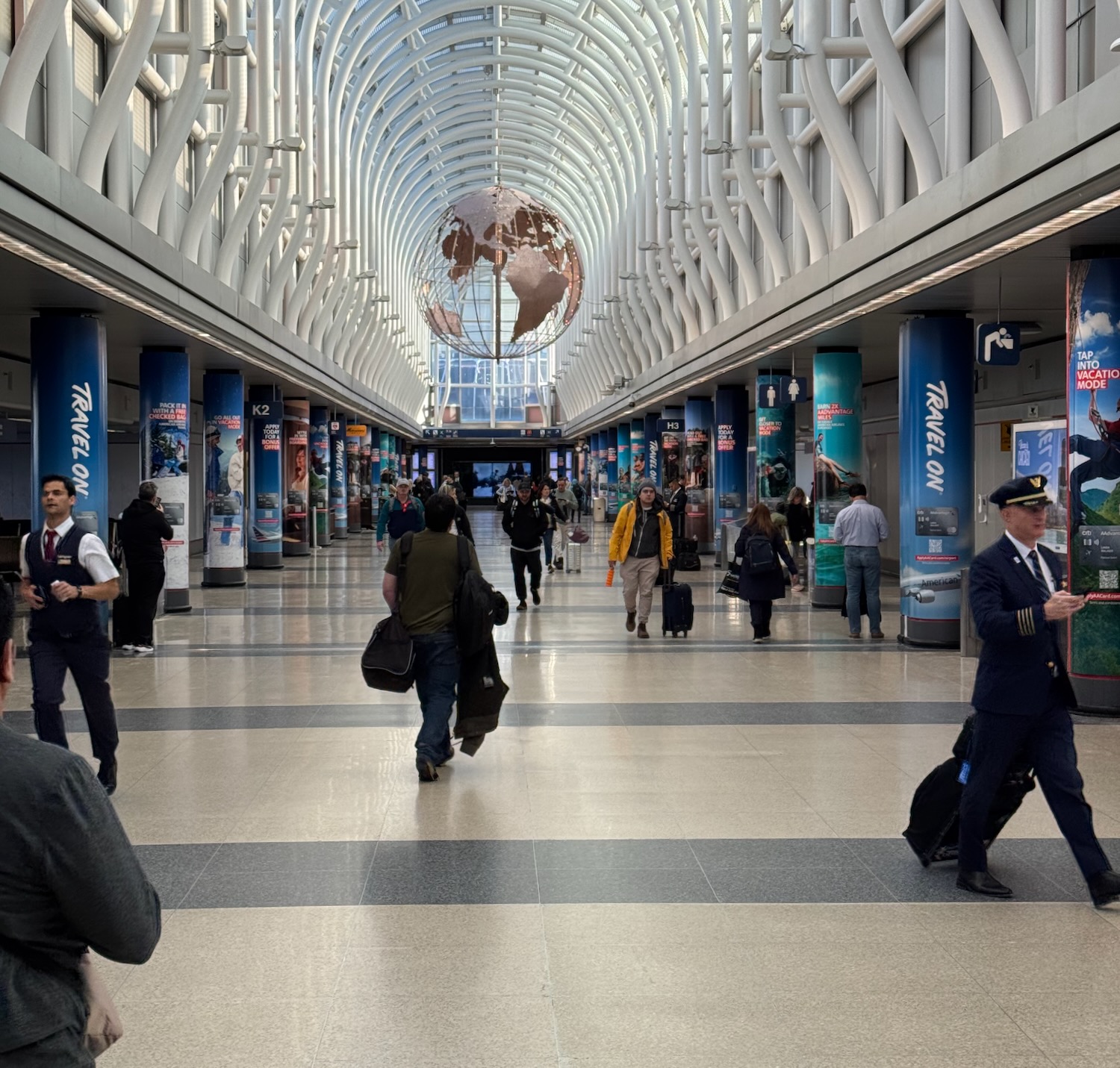 a group of people walking in a large airport