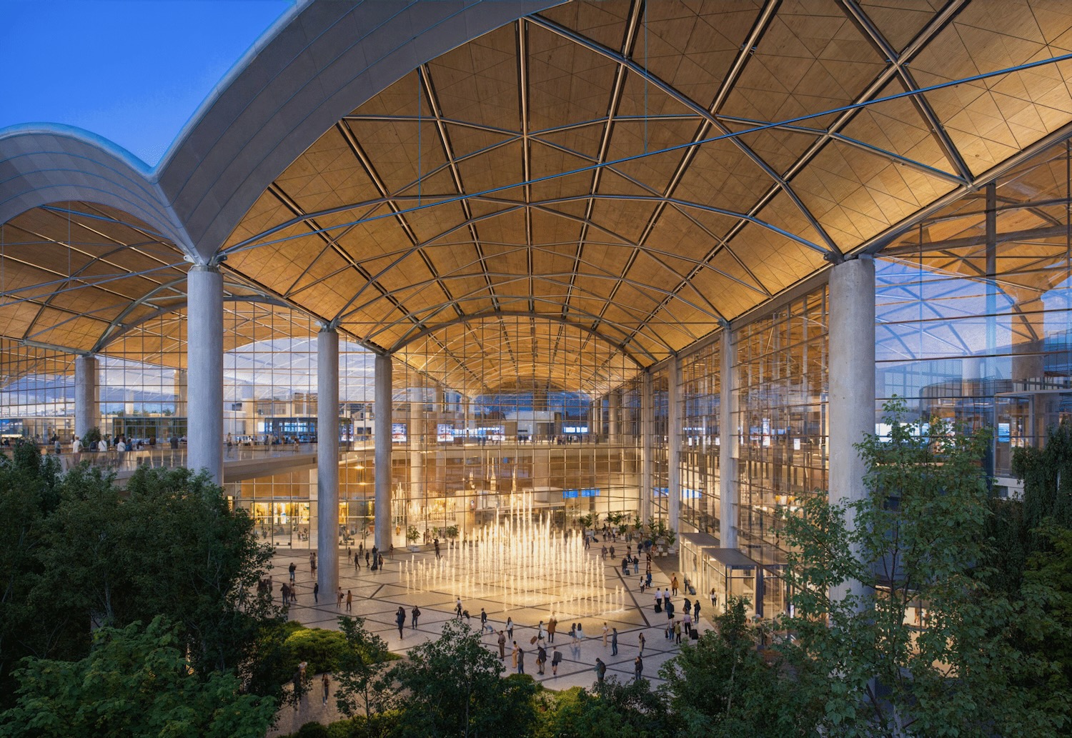 a large glass building with a large ceiling and a fountain
