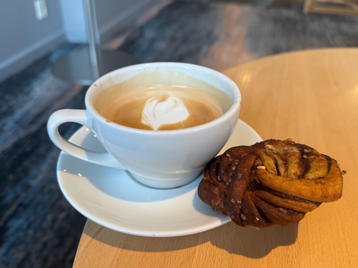 a cup of coffee and a pastry on a plate