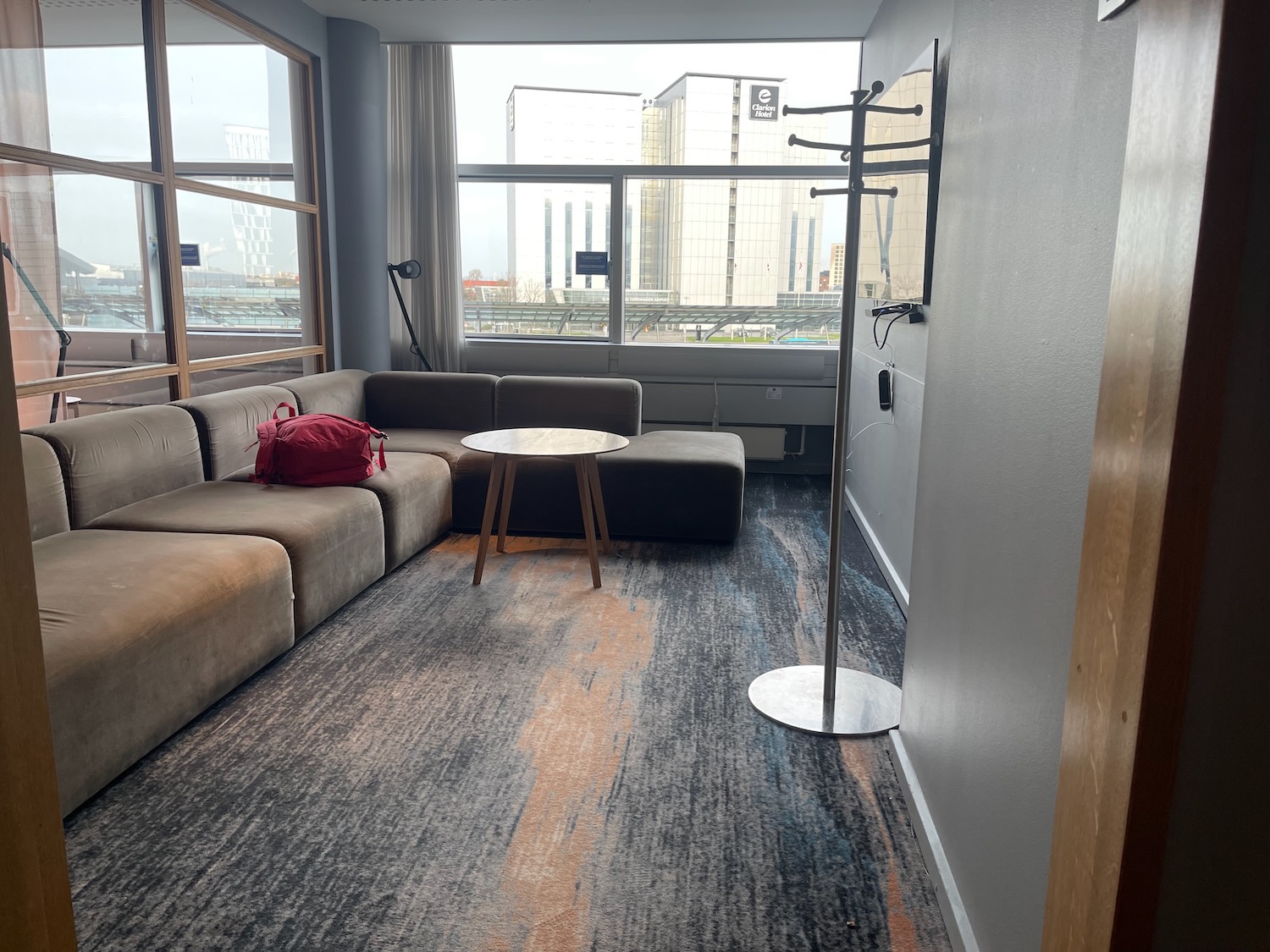 a room with a couch and a coat rack