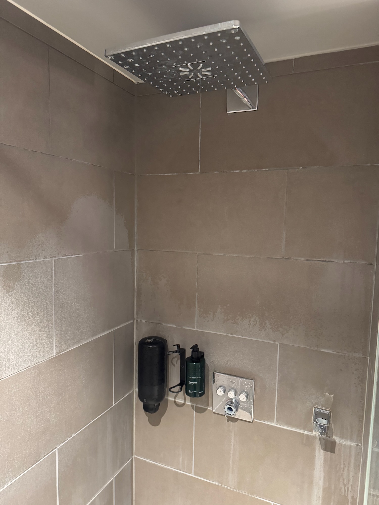 a shower with a shower head and a shower head